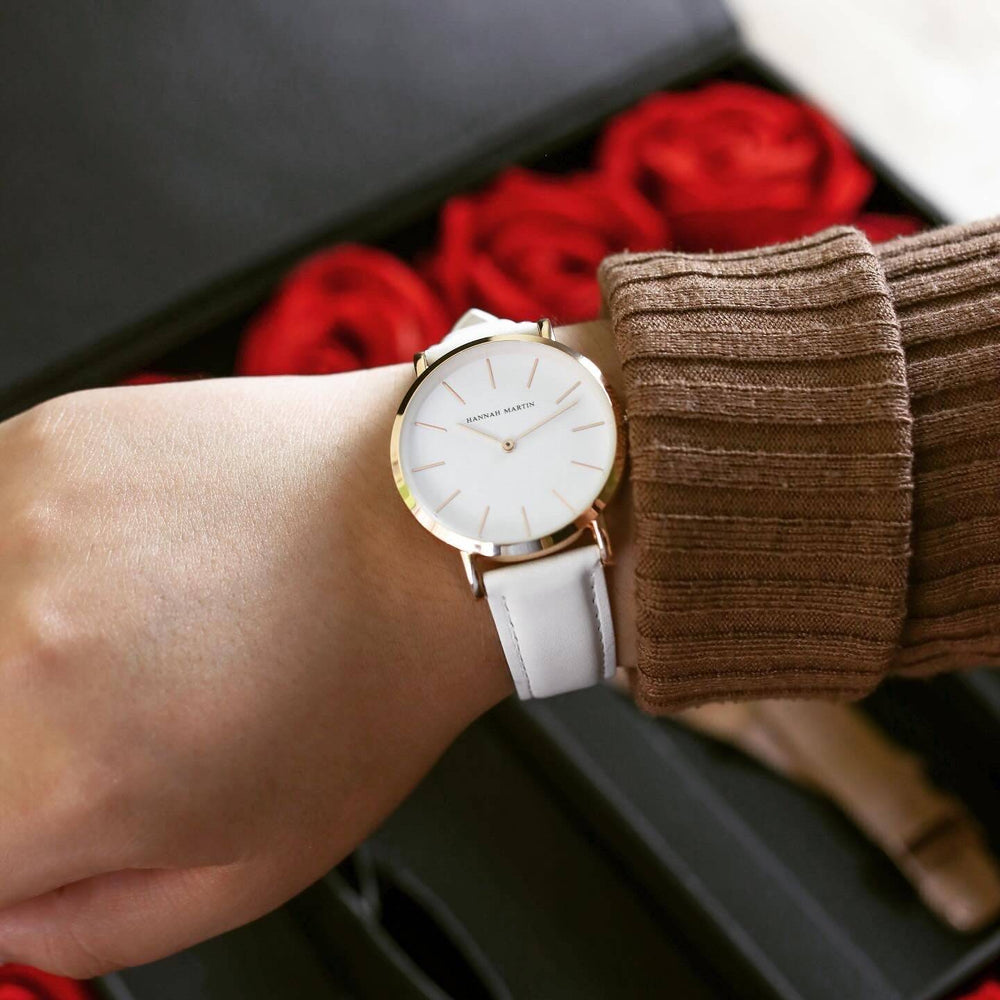 a woman wearing a white watch on her wrist