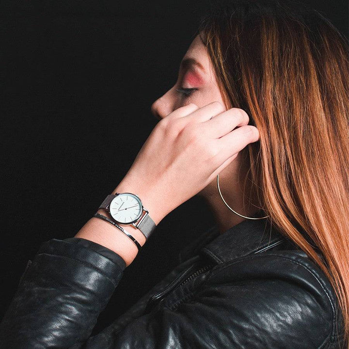a woman with red hair wearing a watch