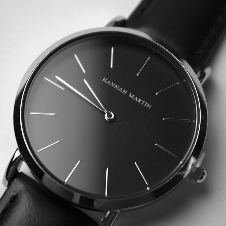 a close up of a watch on a white surface