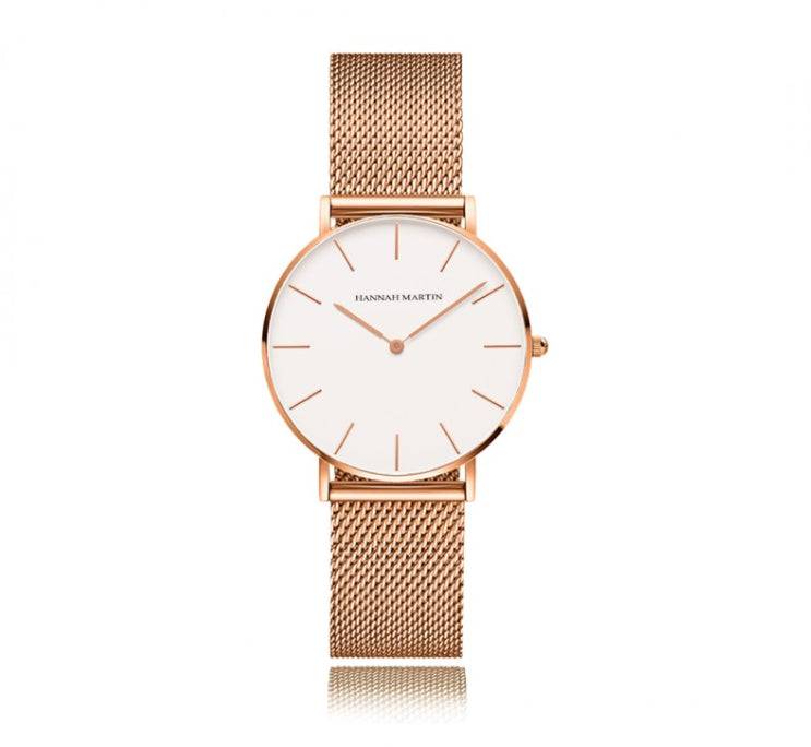 a rose gold watch with a white dial