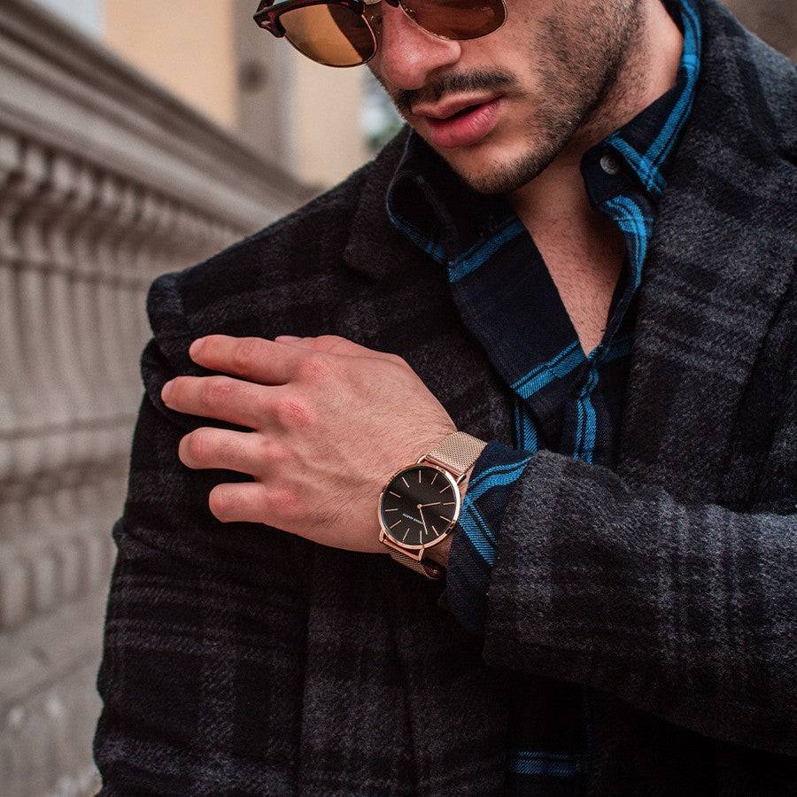 a man wearing sunglasses and a plaid shirt
